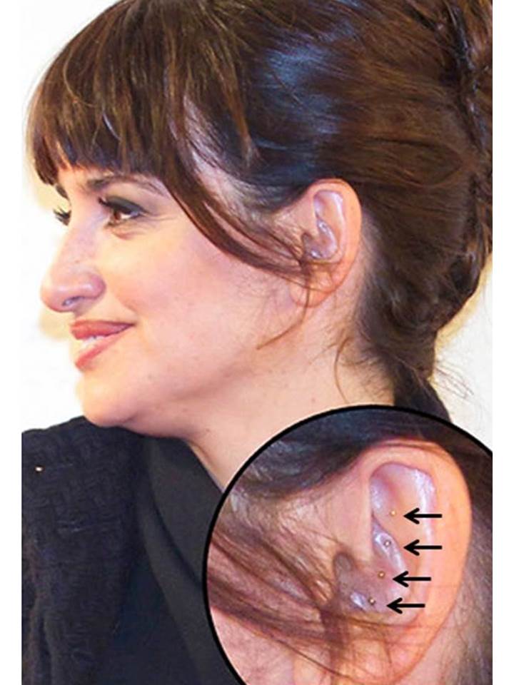 Actress Penelope Cruz shown with gold ASP needles in her left ear